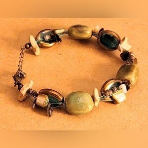 Green and blue multi strand necklace with crown mark